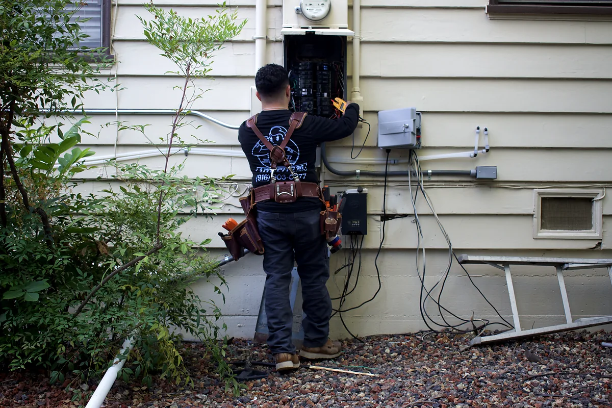 Joseph Perry working at an exterior residential electrical panel