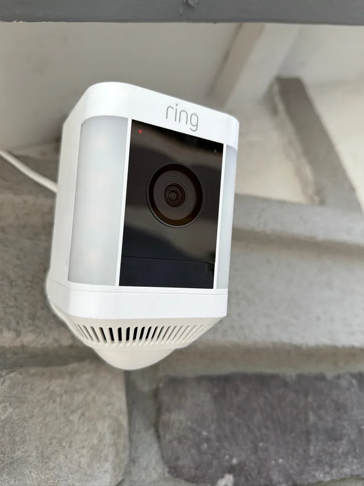 Ring security camera installed beside a residential entry door